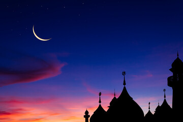 silhouette of dome mosques and crescent moon on dusk sky in the evening 