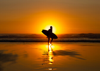 Silhouetted Surfer at Sunset on Widemouth Bay - Bude, Cornwall, England