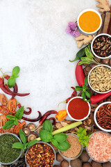 Herb and spice border with fresh and dried herbs and spices on light grunge background with copy space. Flat lay.