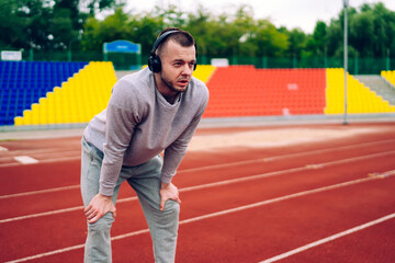 Strong runner resting on track