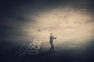 Conceptual scene of finishing the 2020 year, confident and determined businessman crosses the...