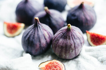 Ripe cut figs on a light background