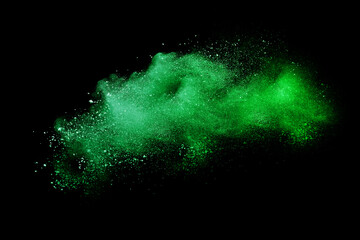 Green powder explosion on black background. Colored cloud. Colorful dust explode. Paint Holi.