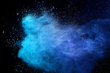 Blue sky color powder explosion on black background.