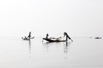 Inle Lake, Myanmar 12/16/2015 traditional Intha fisherman rowing with one leg
