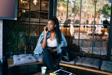 Serious woman talking on phone and looking away