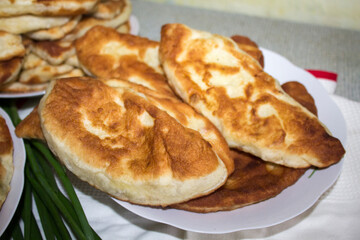 homemade patties from pastry with potato in white plate. Romanian cuisune