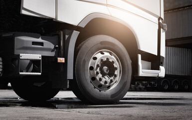 Large a truck wheels of semi truck. Road freight cargo by truck transportation.