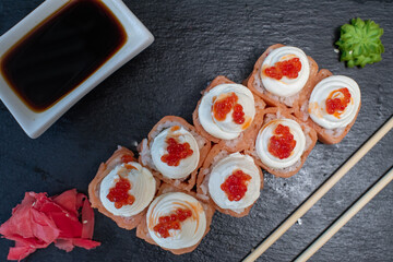Delicious, juicy and appetizing Philadelphia rolls deluxe with red caviar