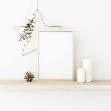 Vertical frame mockup with gold matal star, eucalyptus twigs, pine cones and candles on empty white wall background. Minimalist Christmas interior decoration. A4, A3 format. 3d rendering, illustration