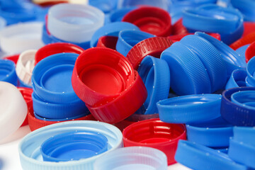 Heap of plastic bottle caps ready for recycling