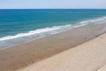 The cold water of the Atlantic Ocean washes onto the sandy beaches of Cape Cod, Massachusetts. This scenic peninsula is a popular summer vacation destination in New England.