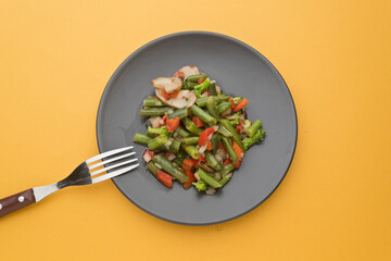 Sauteed vegetables, on orange background. Without people
