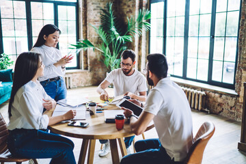 Cheerful colleagues discussing business project