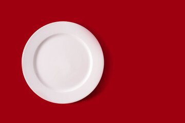 White plate on red background.Christmas food concept
