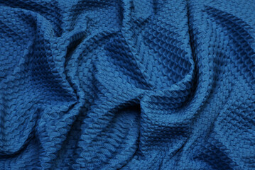 Fototapeta na wymiar Blue surface of fabric. Waving backdrops texture background of clothing
