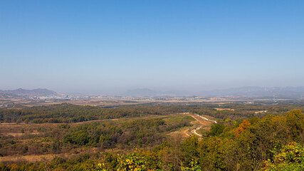 The border fence running through the Korean DMZ from South Korea