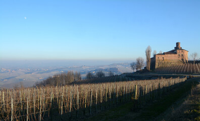 Fototapeta premium The Langhe of Piedmont is a show of hills, vineyards, farms, castles. In autumn the snow-capped Alps become cornices.