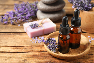 Fototapeta na wymiar Cosmetic products and lavender flowers on wooden table