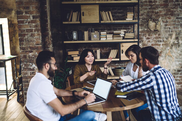 Group of cheerful multiracial colleagues discussing new ideas