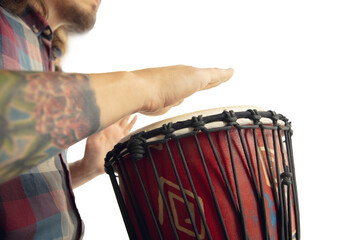 Man plays ethnic drum darbuka percussion, close up musician isolated on white studio background....