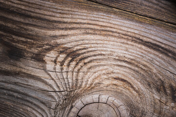 The texture of the aged wooden board in dark shades.