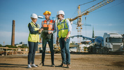Diverse Team of Specialists Use Tablet Computer on Construction Site. Real Estate Building Project with Civil Engineer, Architect, Business Investor Discussing Planning and Development Details.