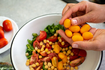 hands hold yellow tomatoes