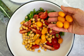 a handful of yellow tomatoes in the palm of your hand