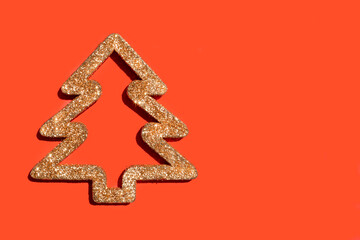Christmas background. Gold decorative Christmas tree on a red background. Top view with place for text.