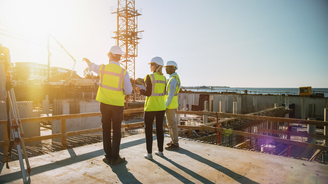 Diverse Team of Specialists Are on Construction Site. Real Estate Building Project with Civil Engineer, Architect, Business Finance Investor Discussing Planning and Development Details. Warm Sun Flare
