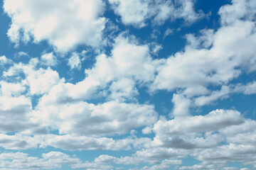 Clouds in blue sky. White, fluffy clouds In blue sky. Background nature. Texture cumulus floating on blue sky. Backgrounds concept. Environment, atmosphere. Place for an inscription or logo