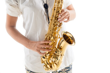 Obraz premium Close up woman playing saxophone isolated on white studio background. Inspired musician, details of art occupation, world classic instrument for jazz and blues. Concept of hobby, creativity.