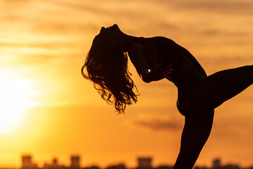 silhouette of ballet dancer at sunset