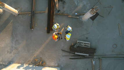 Aerial Top Down Shot of a Constructions Site with Diverse Team of Engineers and Worker with...