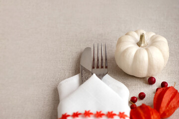 Thanksgiving Day or Halloween place setting with mini white pumpkins