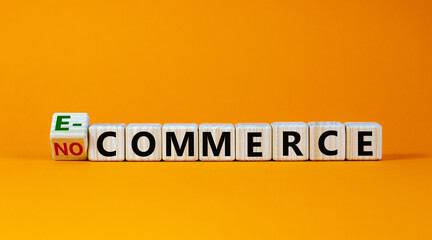 Turned the cube and changed the expression 'no commerce' to 'e-commerce'. Beautiful orange background. Business concept. Copy space.