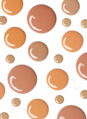Liquid foundation drops isolated on white background. Makeup color swatches.