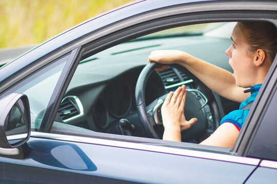 Woman Drives A Car, Nervous And Angry Horns. A Road Accident.