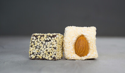 delicious Turkish Delight with walnuts and sesame seeds on gray background