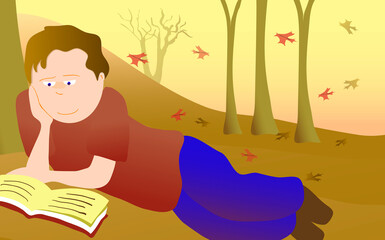 Obraz na płótnie Canvas Boy lying in a park and reading a book