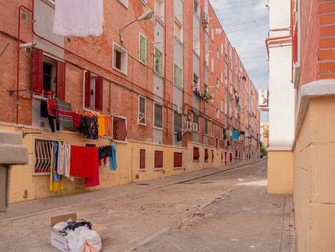 POOR NEIGHBORHOOD STREET WITH LAYING CLOTHES AND GARBAGE
