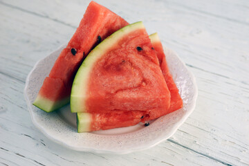Slices of ripe watermelon on a white plateSlices of ripe watermelon on a white plate