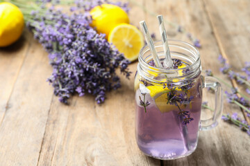 Fresh delicious lemonade with lavender in masson jar on wooden table. Space for text