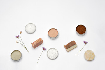 Obraz na płótnie Canvas Ingredients for the production of cosmetics on a white background. Clays, wax, herbal powders, dried flowers, raspberry ketone. Natural cosmetics concept.
