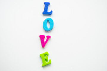 the word love is laid out in colored letters on a white background