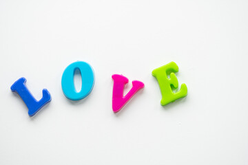 the word love is laid out in colored letters on a white background