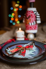 Traditional Christmas table setting. Cutlery, china plate, Christmas decorations. Holidays background.