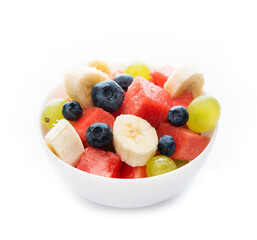 Fresh fruit salad on a plate, isolated on a white background