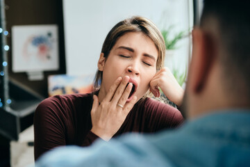 Woman Yawning During Boring Conversation With Partner